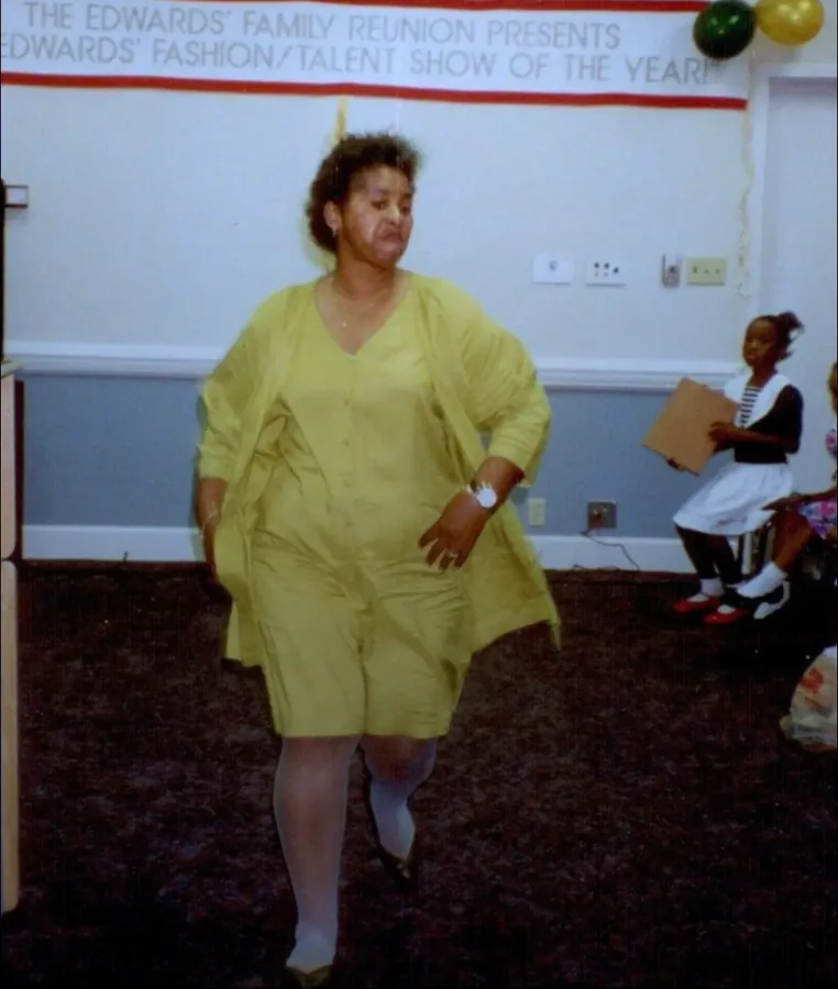 A woman in yellow walking the runway at the Edwards family fashion and talent show.