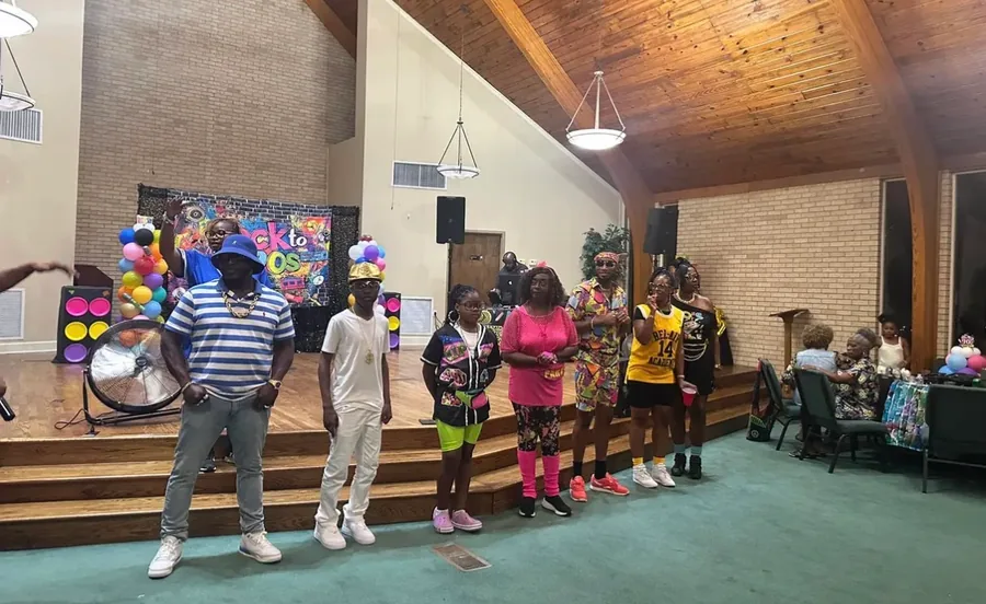 Performers on stage at a reunion talent show.